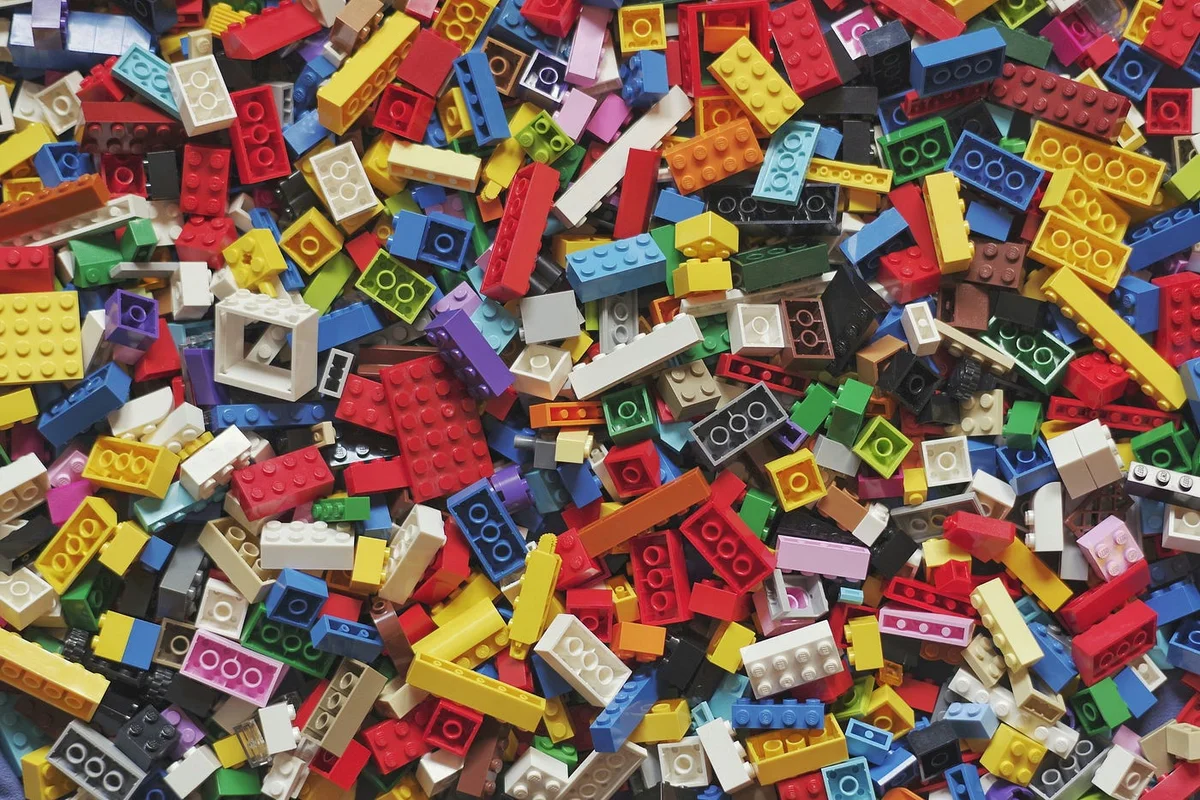 Scattered Lego bricks on a yellow background